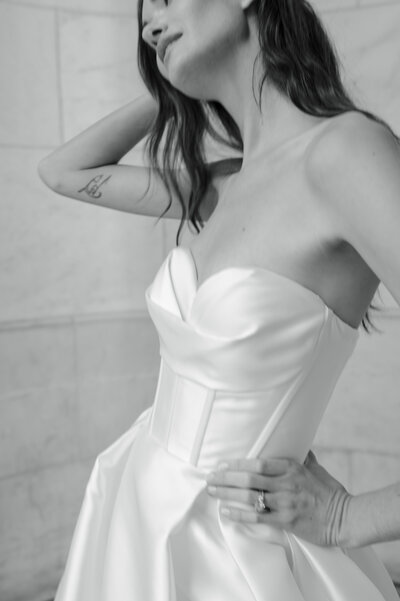 black and white image bride wearing strapless satin wedding dress