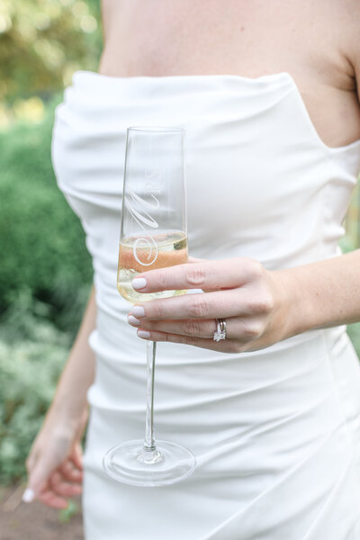 A classic bride holding a glass of champagne 