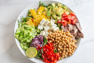 Colourful, healthy summer salad on a marble counter.