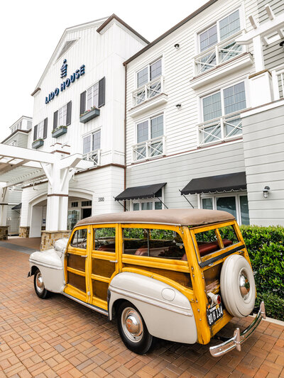 Vintage Woody car parked in front of Lido House, a coastal luxury hotel in Newport Beach