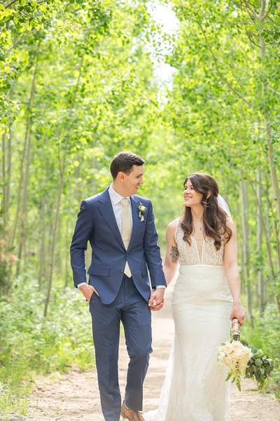 elopement couple in a tunnel of aspens