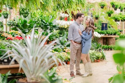 Engaged couple standing in greenhouse garden | Alabama wedding photographer Amanda Horne