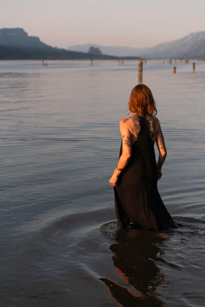 yoga teacher walking out into the river