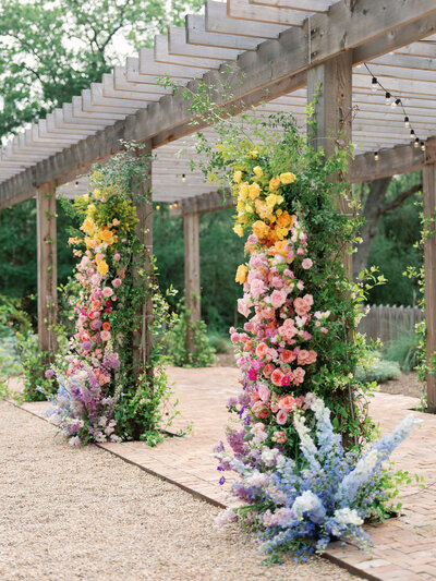 Colorful wedding ceremony arch planned by Bianca Nichole and Co