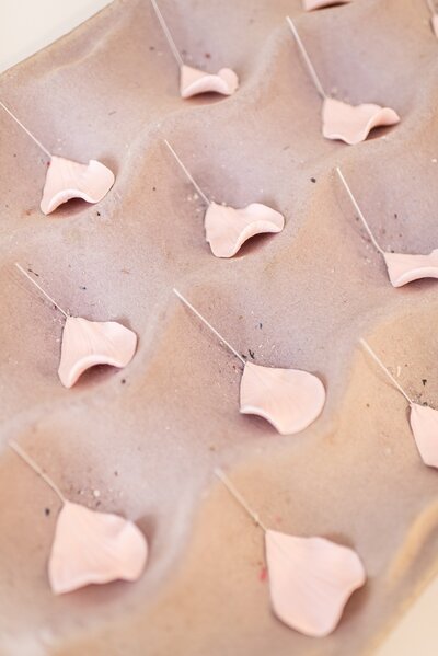 a tray of gumpaste flower petals drying on a petal former