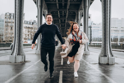 The MacMeekens in Paris running and laughing while under the Bir Hakim Bridge