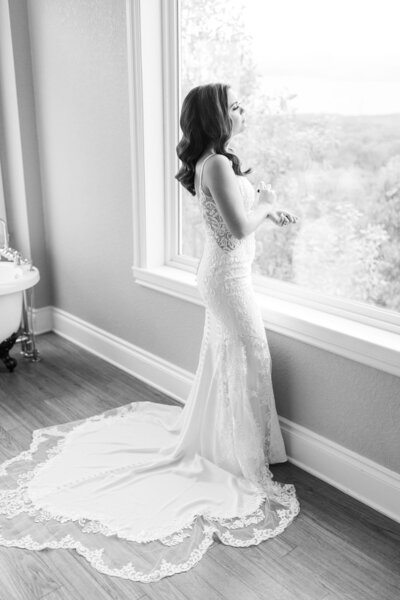A bride looks out the window.