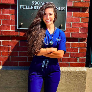 Amtheh Coda from the DePaul Student Nurses Association smiles in her scrubs.