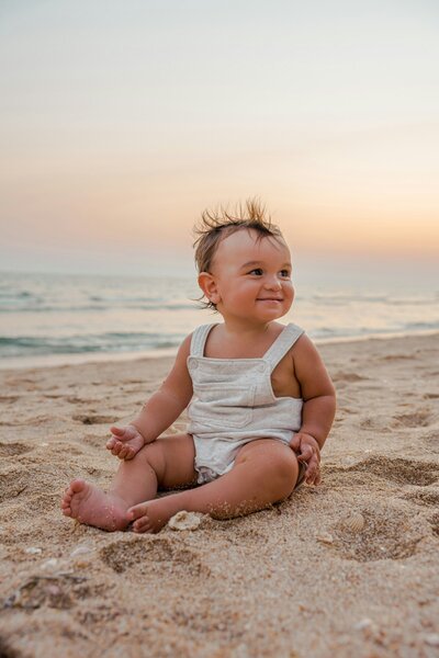 baby sat on beach