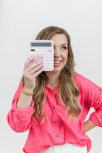 Erika playfully holding a pink calculator over one of her yes