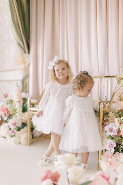 Two little girls in white dresses