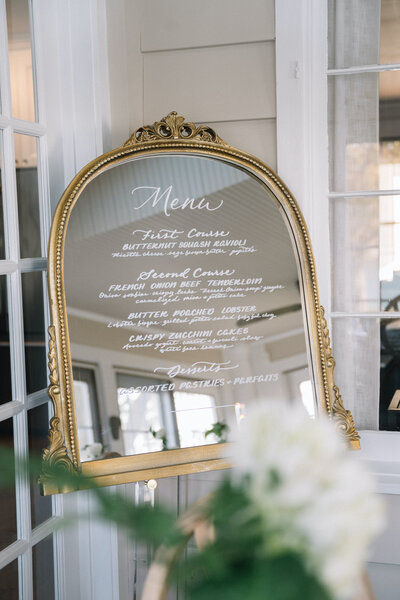 Ornate gold mirror with handlettered menu for Westbrook, Connecticut wedding
