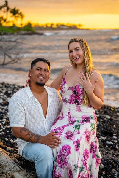 Couple showing off engagement ring during golden hour, taken by Hawaii engagement photographer