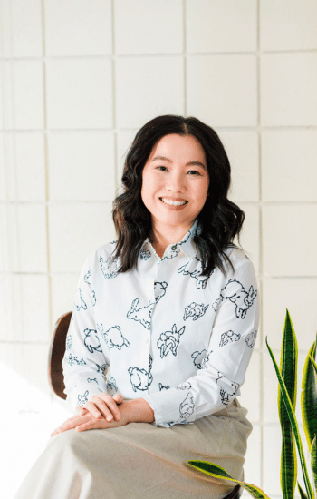 Joanne Lai a somatic therapist in Fresno sitting and smiling
