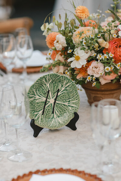 Handwritten black table number on vintage green cabbage plate for wedding at Winvian in Litchfield County, Connecticut