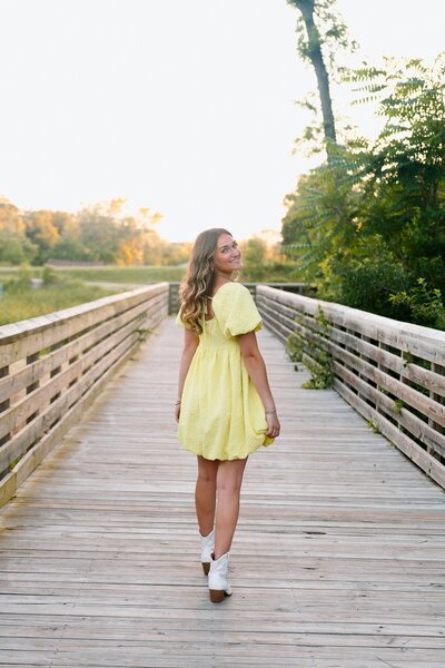 girl poses for senior photos in kansas city missouri