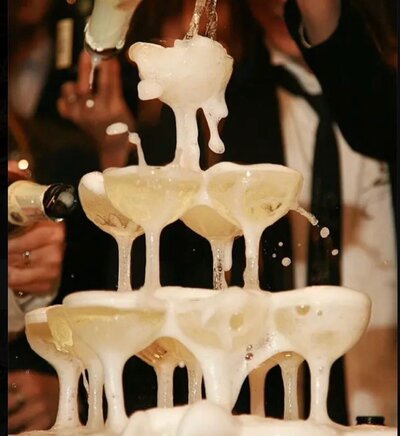 Drink tower overflowing with champagne pouring down