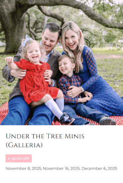 beautiful tree and joyful family with two kids laughing and dressed in red and blue for Christmas