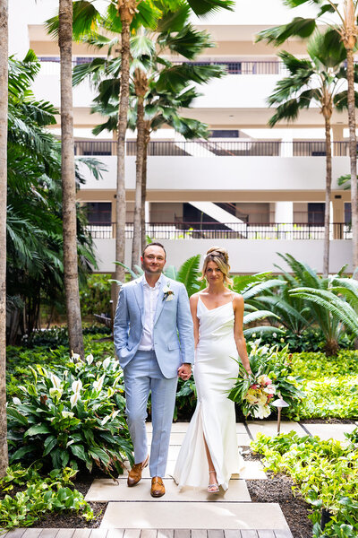 Bride and groom at the mauna lani auberge getting ready for their luxury wedding
