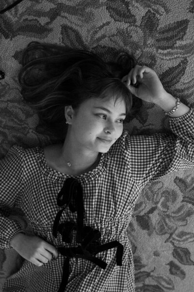 A candid portrait of Ember Claire, the lead photographer, exuding warmth and approachability, reflecting her passion for storytelling through non-intrusive observation.