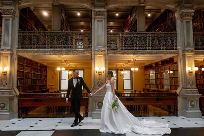 Wedding at George Peabody Library in Baltimore, couple holding hands