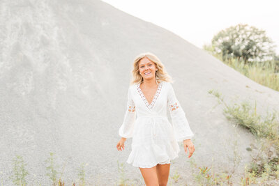 Blonde girl smiling for senior photos