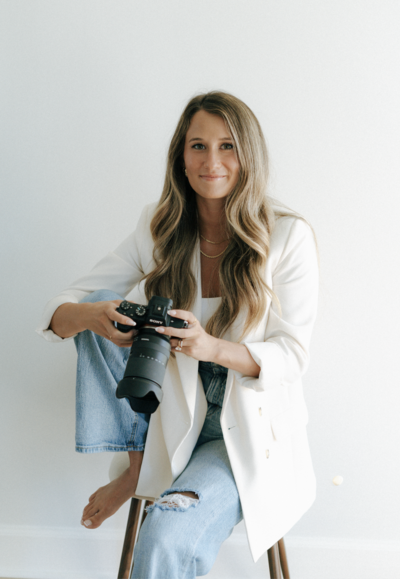 Portrait of Kelsey, wedding photographer, smiling in a professional setting.