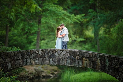 engagement photos on bridge - couple kissing