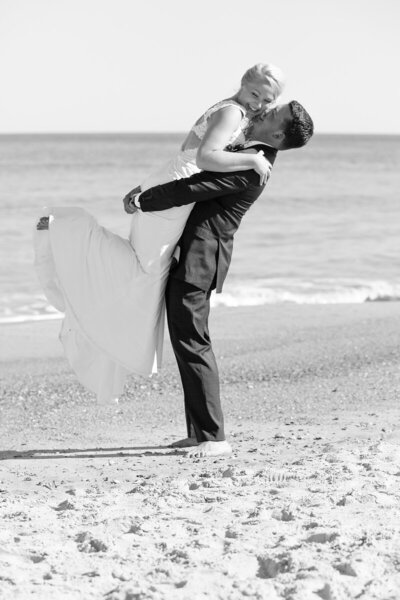 "Groom lifts Bride for a kiss on Wrightsville beach"