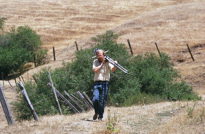 Young Photographer Fred W. Gillaspy and his view camera out shooting on a California hillside.