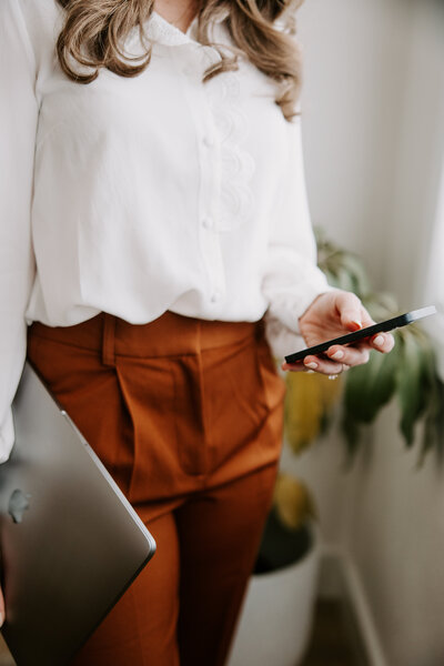 Website copywriter Erika Fitzgerald looking at an iPhone