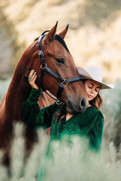 blonde girl posing with sports horse