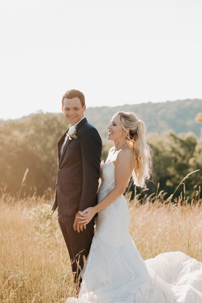 engaged couple laughing on the Blue Ridge Parkway at sunset