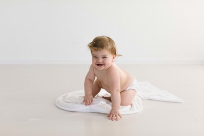 pregnant woman holding her belly with her hands during a photography session with Laurie Baker