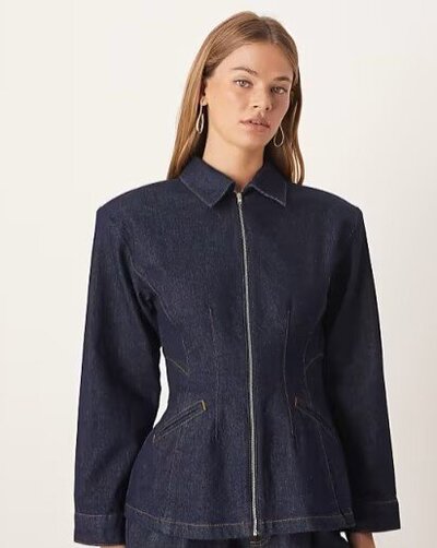 ASOS DESIGN denim cinched barn jacket in indigo with zip front and tailored waist, styled as a trendy fall outerwear piece.