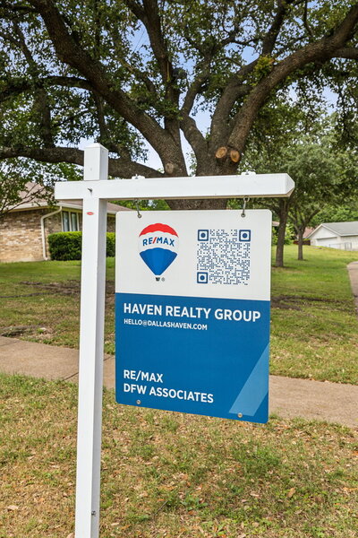 Haven Realty Group RE/MAX DFW Associates real estate sign with QR code in front yard of Dallas home for sale, showcasing modern marketing strategy for home sellers.