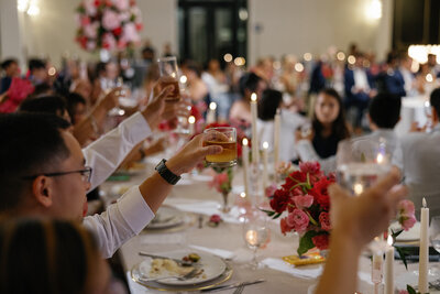 bride is pouring champagne into their champagne tower during their colorado wedding day.