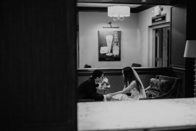 Black and white image of bride and groom looking at each other after a ketubah signing