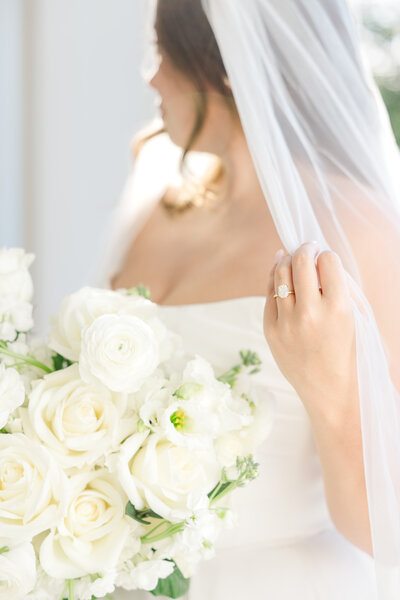 bride stands in front of San Antonio wedding venue stairs leading up to a big wooden door