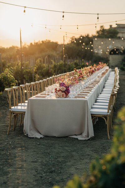 Maila taking couple to see their tablescape at Luxury Wedding planned by Maila Enea in London & Sicily