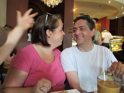 Heather Cook smiling at her husband Gordon Cook in a coffee shop.