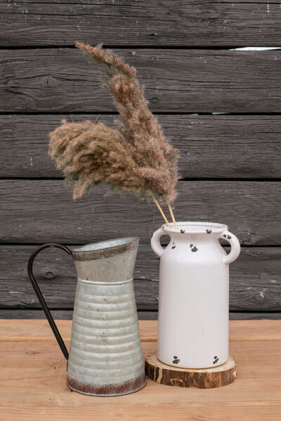 tin pitcher and white vase
