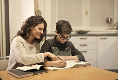 Mutter und Sohn machen gemeinsam Hausaufgaben.