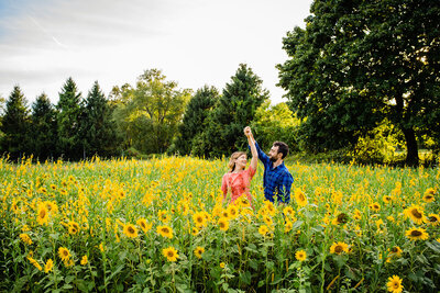 engaged couple dancing in sunflower field in vermont