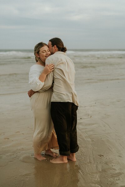 A candid and authentic photo from a Urunga Bellingen engagement photography session on the beach