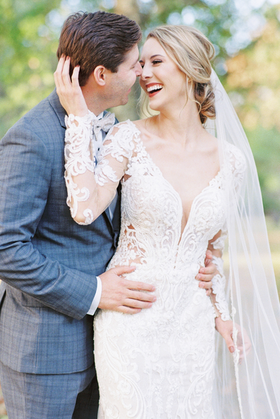 A bride and groom laugh together intimately by Huntsville wedding photographer, Kelsey Dawn Photography
