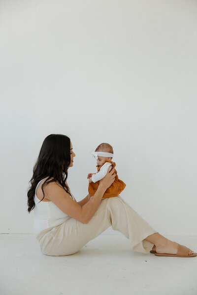 baby and mom snuggle during family photos in madison wisconsin