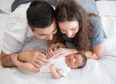 Young couple having newborn lifestyle photos taken in home by family photographer Brisbane, Hikari Lifestyle Photography.