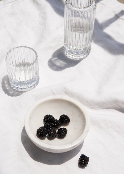 Healthy snack of blackberries and hydrating with water