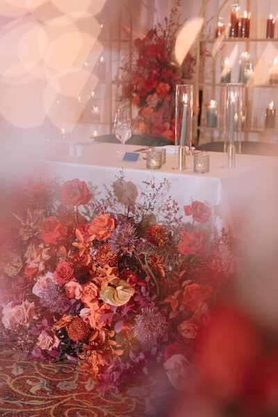 Colorful floral arrangements at wedding reception planned by Bloom & Blueprint